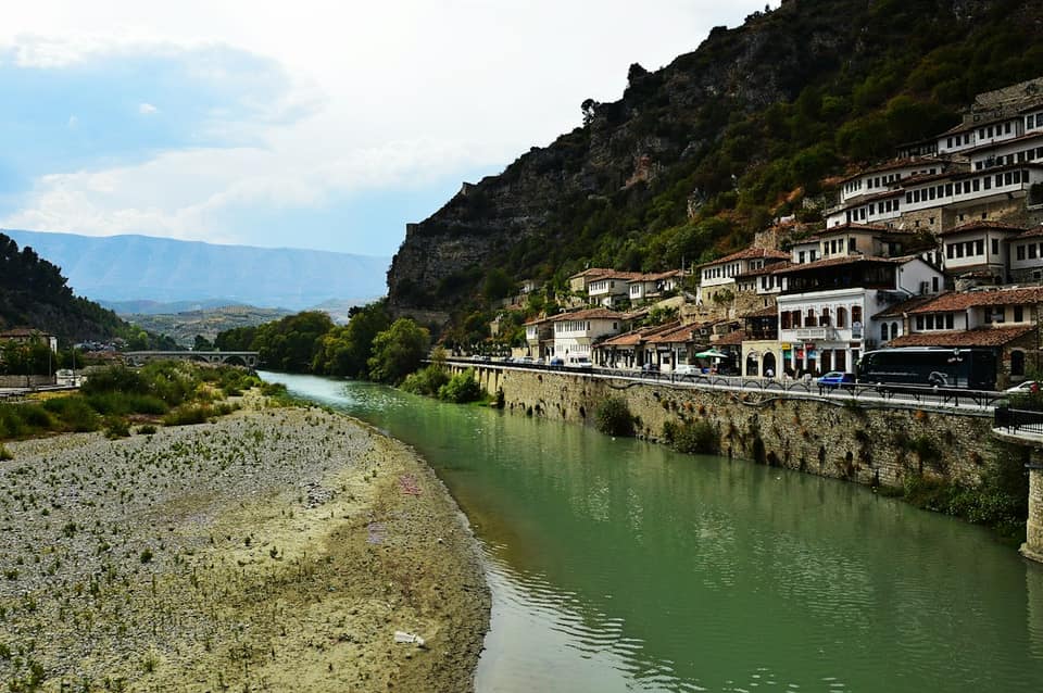 A river running through a lush green valley