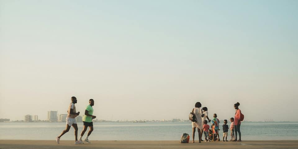 People are on a beach, near the water