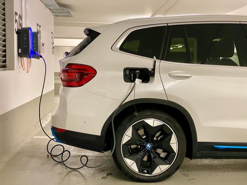 An electric car plugged in to a charging station