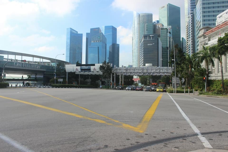 An empty parking lot in a city with tall buildings