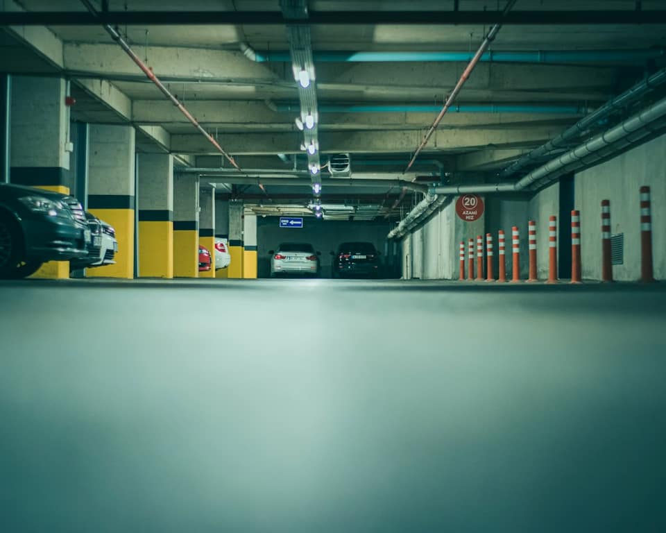 A parking garage with cars parked in it