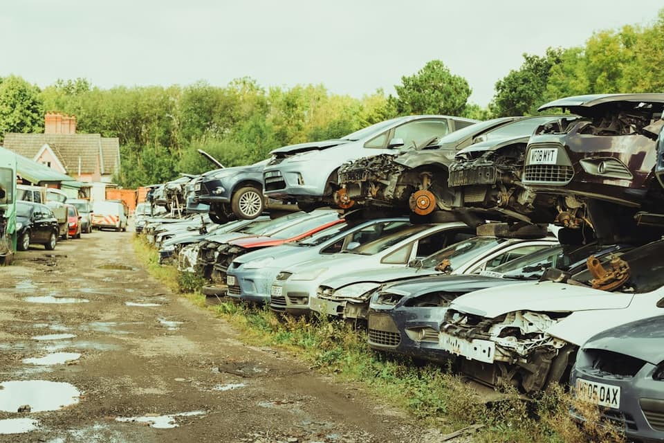 A bunch of cars that are sitting in the dirt