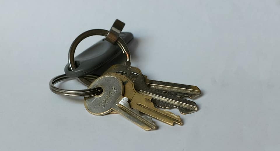 Silver keys on white table