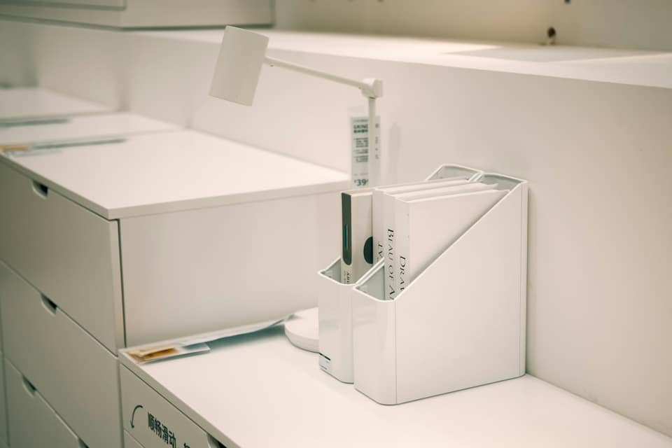 White office organizer with files on desk