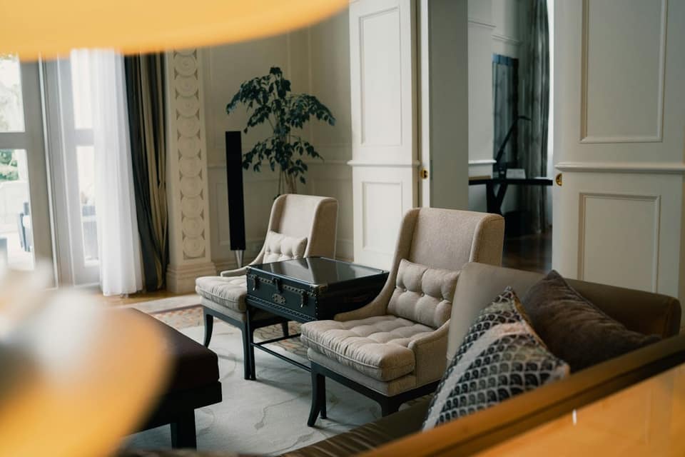 Black and white sofa chair near white window curtain