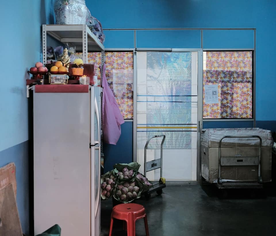 White top mount refrigerator beside white plastic container