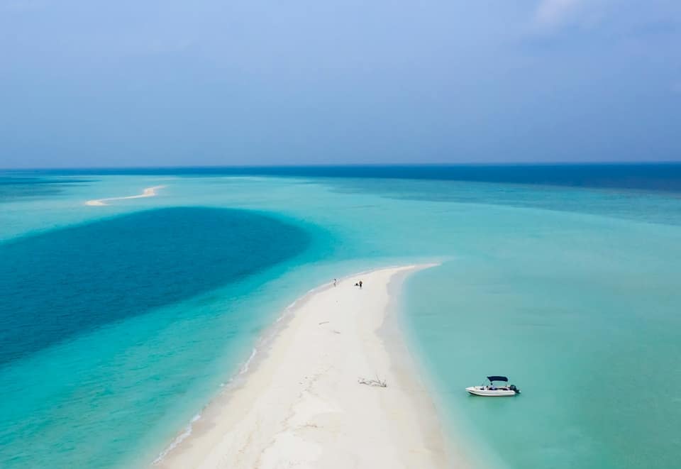 White boat on blue sea water during daytime